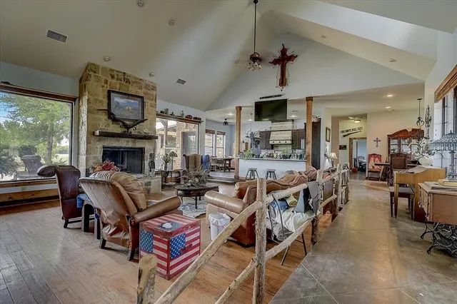 a living room with fireplace furniture and a large window