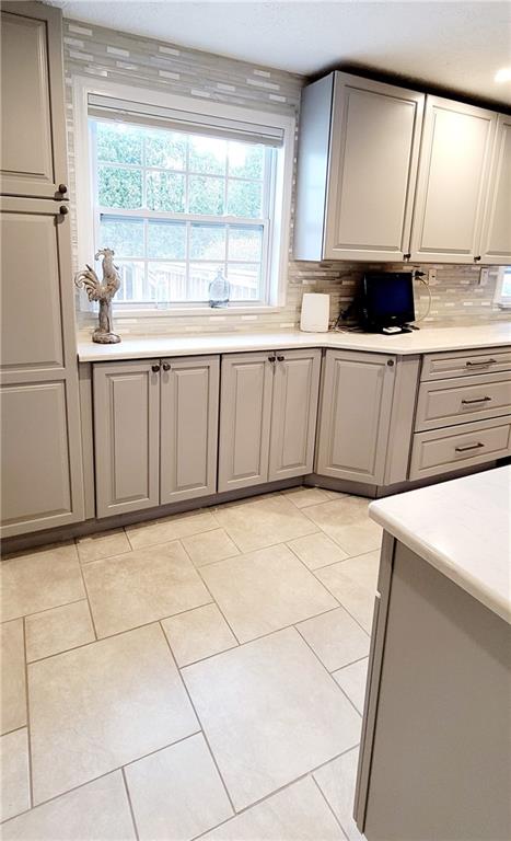 5107 McCandless Road Butler, PA 16001 - Photo 12 of 25 a view of a kitchen with a sink a microwave and cabinets