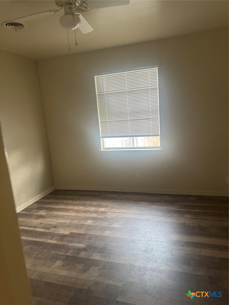 904 Houston Street Killeen, TX 76541 - Photo 4 of 17 an empty room with a empty space and windows