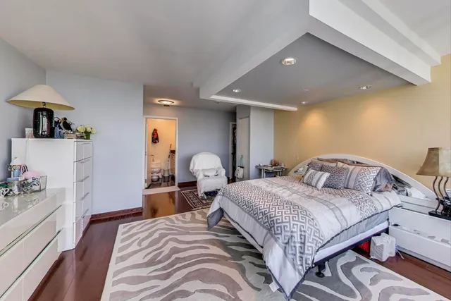 a bedroom with double bed and a large window