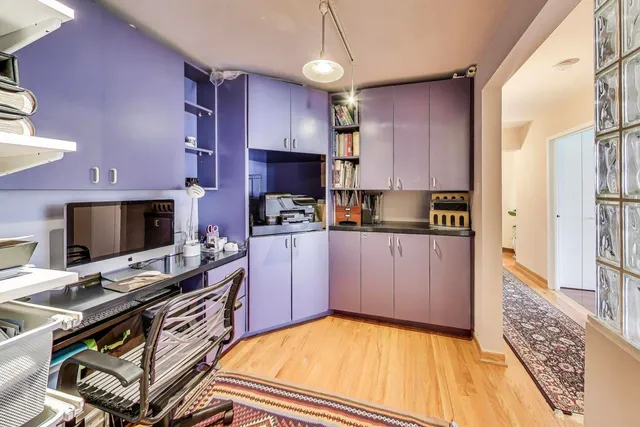 a kitchen with a refrigerator and a stove top oven