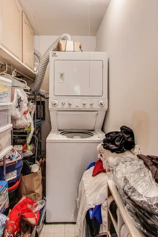a bathroom with a granite countertop sink toilet mirror and shower