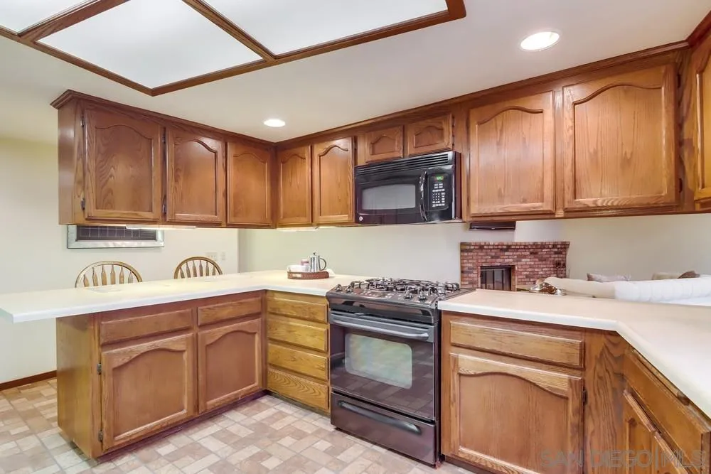 13256 Mapleview Street Lakeside, CA 92040 - Photo 24 of 58 a kitchen with a sink stove top oven and cabinets