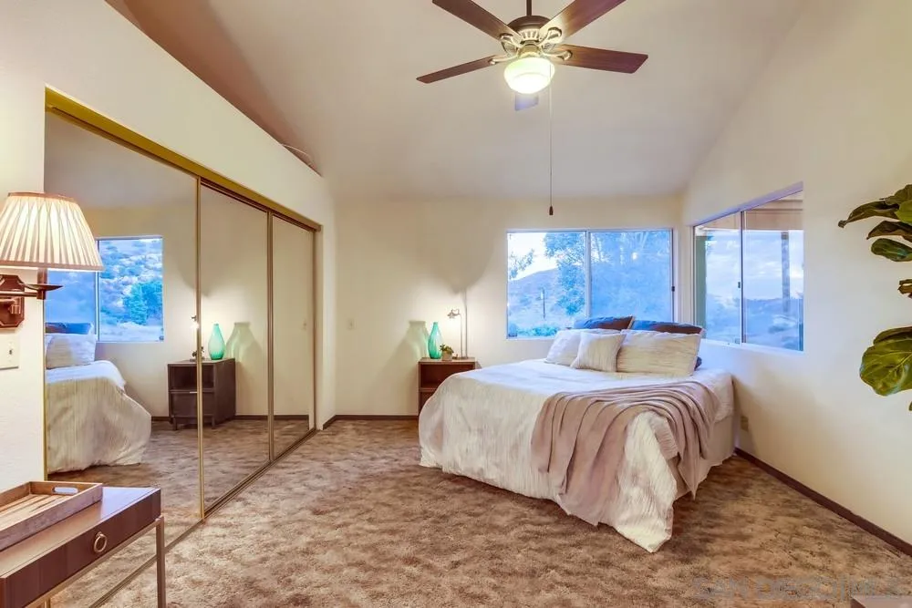 13256 Mapleview Street Lakeside, CA 92040 - Photo 30 of 58 a bedroom with a bed and a chandelier