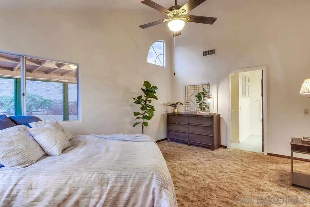 13256 Mapleview Street Lakeside, CA 92040 - Photo 31 of 58 a bedroom with a bed chandelier and a window