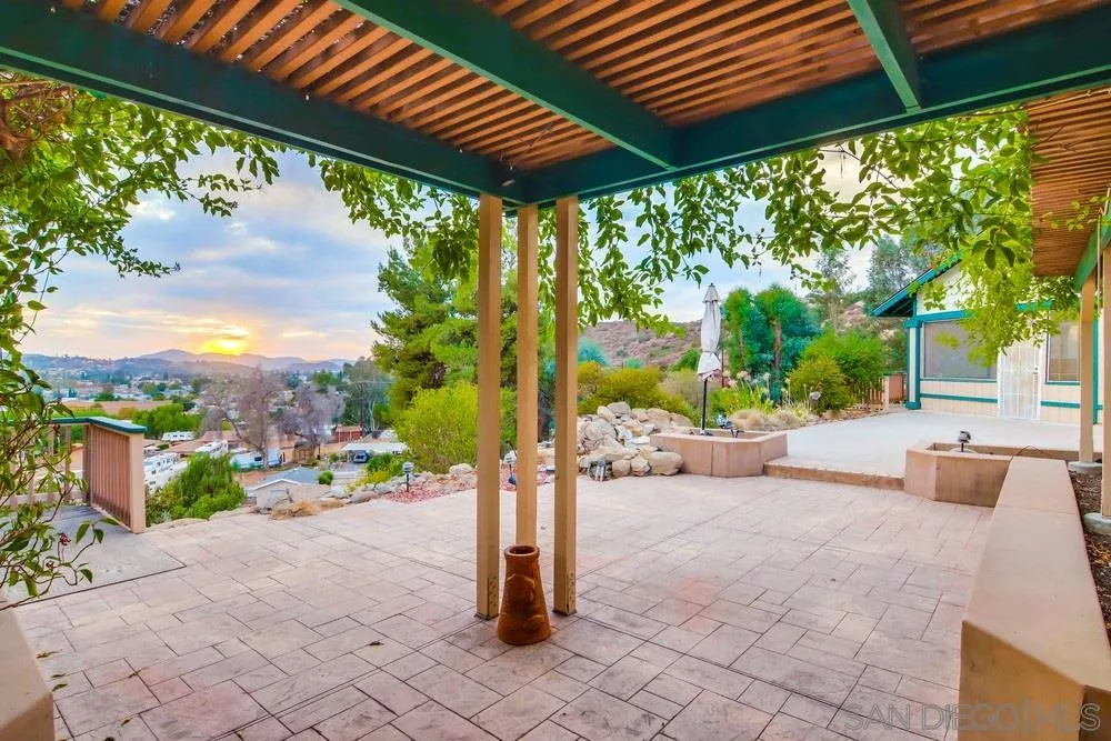 13256 Mapleview Street Lakeside, CA 92040 - Photo 43 of 58 a view of a patio with a table chairs potted plants and palm tree
