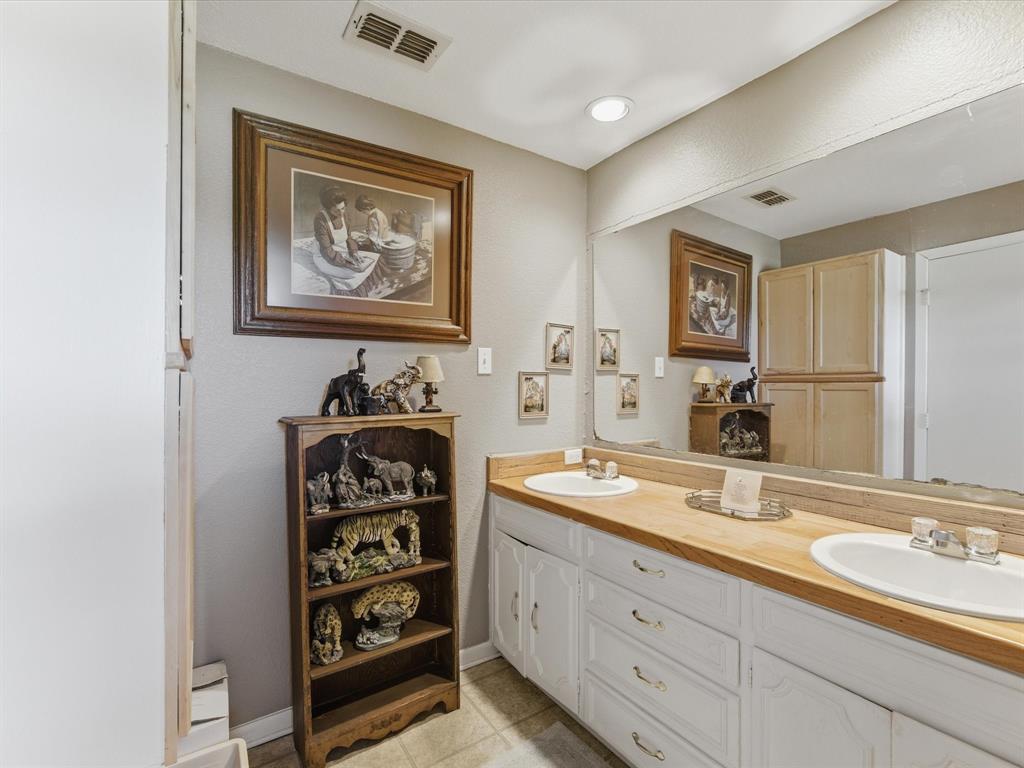 301 Ovilla Road Waxahachie, TX 75167 - Photo 27 of 38 a bathroom with double sink and a mirror