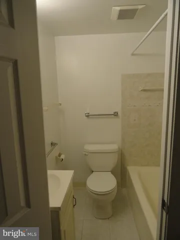 a white toilet sitting next to a small sink