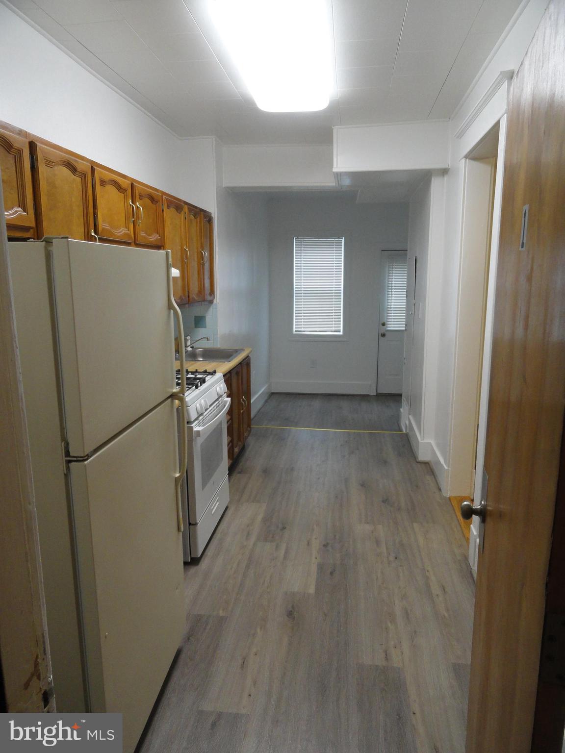 439 Quincy Street Northwest, Unit 1 Washington, DC 20011 - Photo 16 of 19 a white refrigerator freezer and a stove sitting inside of a kitchen