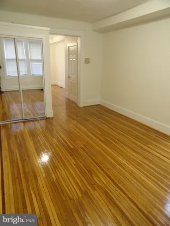 a view of a room with wooden floor and windows