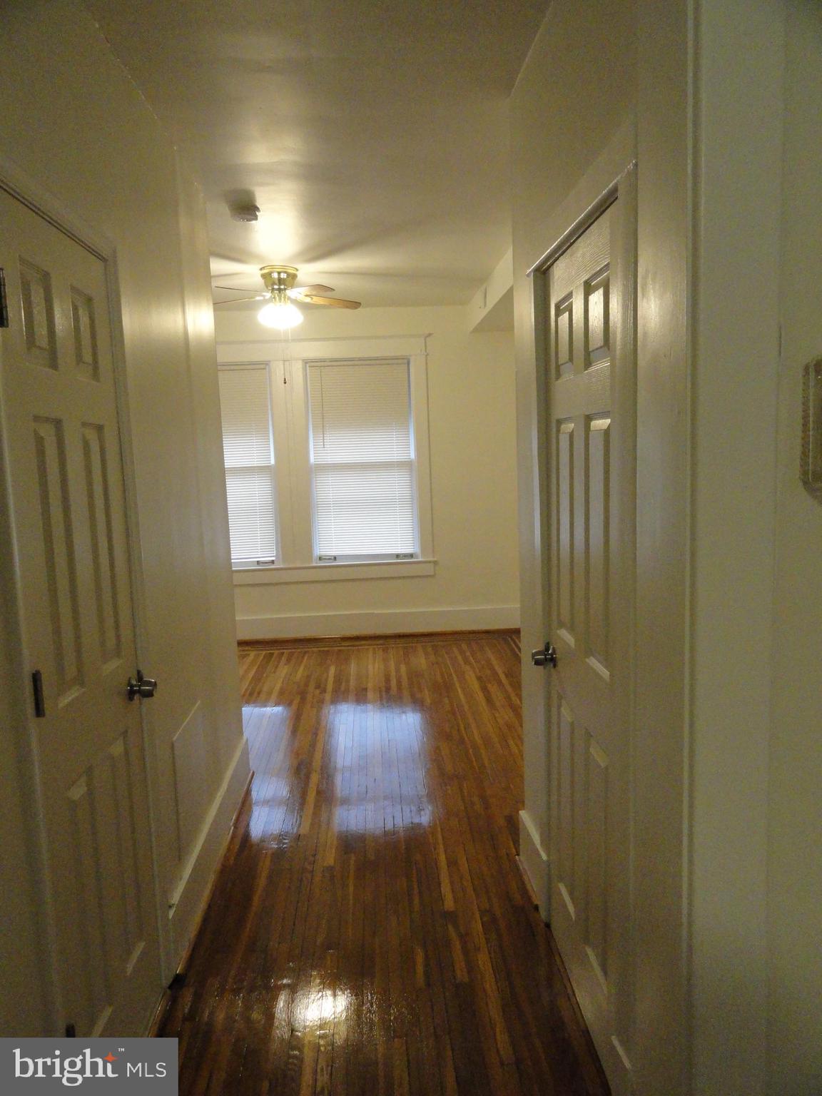 439 Quincy Street Northwest, Unit 1 Washington, DC 20011 - Photo 6 of 19 a view of a hallway with wooden floor and a bathroom