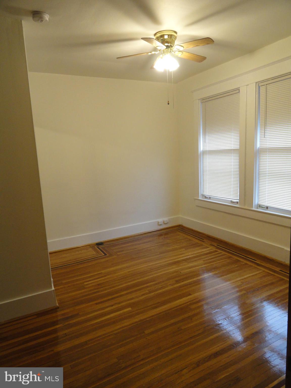 439 Quincy Street Northwest, Unit 1 Washington, DC 20011 - Photo 10 of 19 a view of an empty room with wooden floor and a window