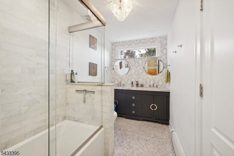 48 Woodmont Road Montclair, NJ 07043 - Photo 8 of 20 a bathroom with a tub sink and mirror