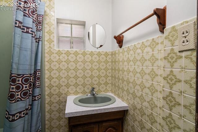 28018 County Farm Road Pueblo, CO 81006 - Photo 13 of 50 Bathroom featuring tile walls and vanity