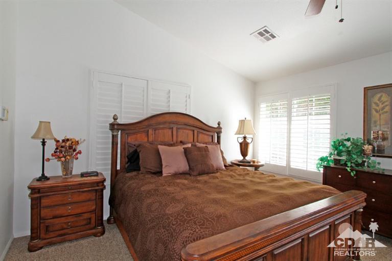 68565 Senora Road Cathedral City, CA 92234 - Photo 18 of 37 a bedroom with a bed and a potted plant on dresser