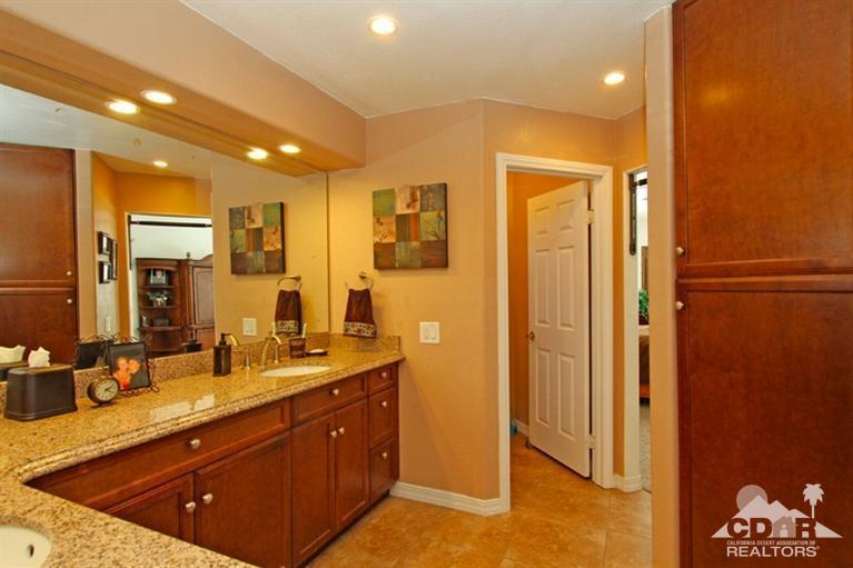 68565 Senora Road Cathedral City, CA 92234 - Photo 21 of 37 a bathroom with a double vanity sink a mirror and a shower