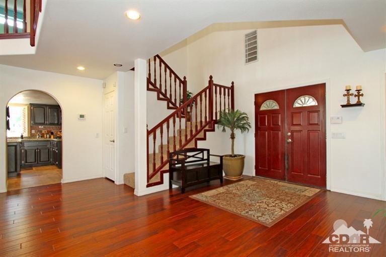 68565 Senora Road Cathedral City, CA 92234 - Photo 3 of 37 a view of a hallway with wooden floor and furniture