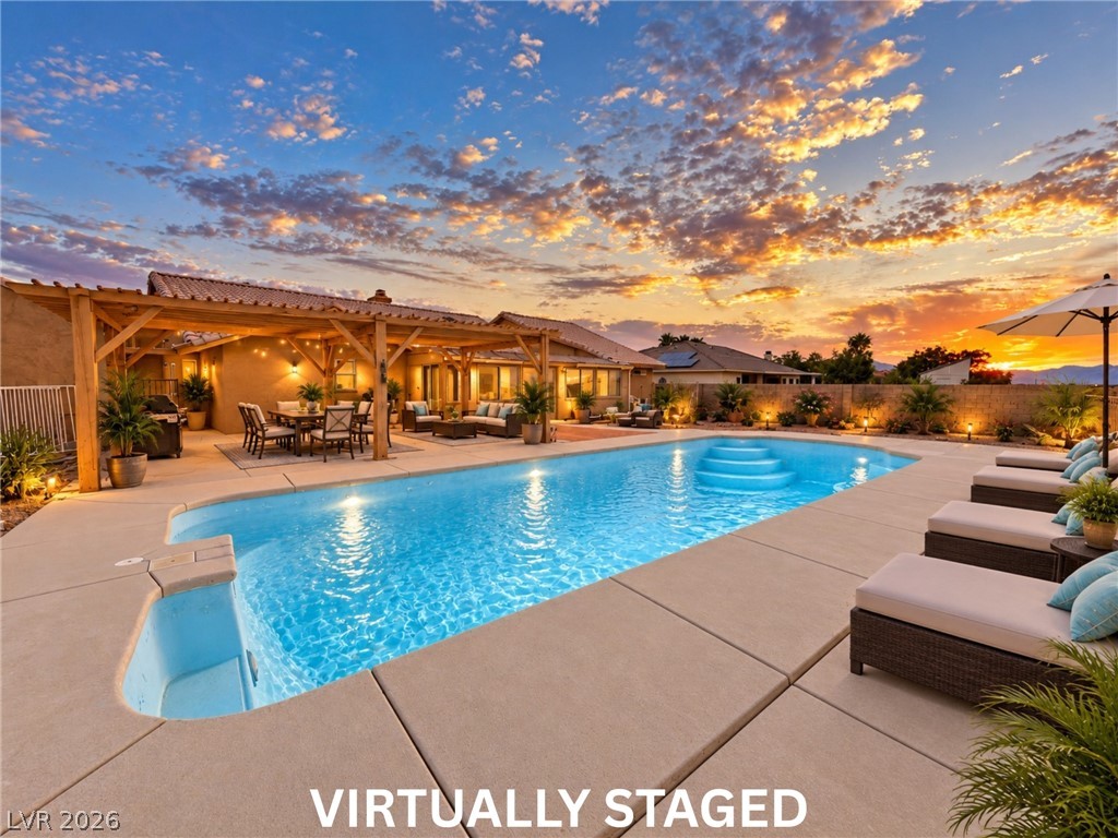 5470 Grain Mill Road Pahrump, NV 89061 - Photo 60 of 80 VIRTUALLY STAGED An inviting backyard oasis features a glistening swimming pool alongside a spacious covered patio.