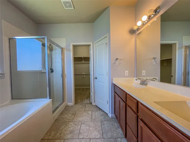 a spacious bathroom with a bathtub sink and shower