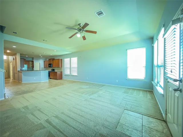 a view of empty room with wooden floor and window