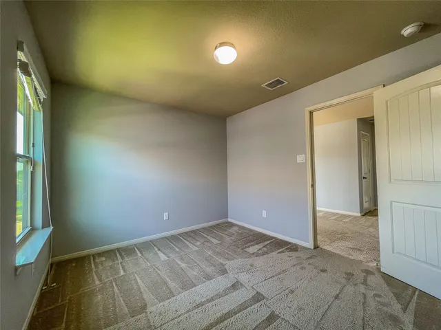 a view of empty room with windows