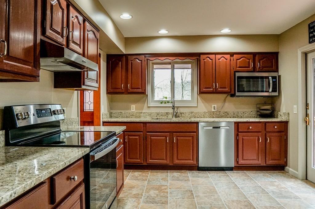33 Murphy Road North Brookfield, MA 01535 - Photo 13 of 30 a kitchen with stainless steel appliances granite countertop a sink stove and cabinets