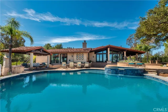 a view of house with swimming pool yard and outdoor seating