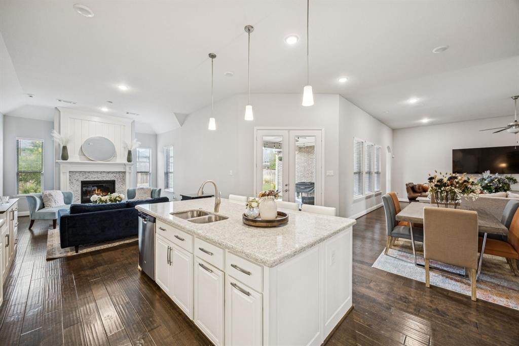 8116 Tramore The Colony, TX 75056 - Photo 11 of 36 a kitchen with kitchen island a stove a table and chairs in it