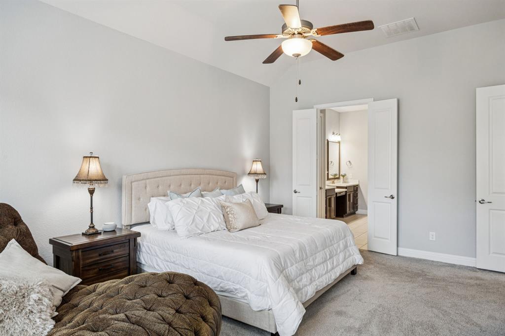 8116 Tramore The Colony, TX 75056 - Photo 16 of 36 a bedroom with bed and a chandelier