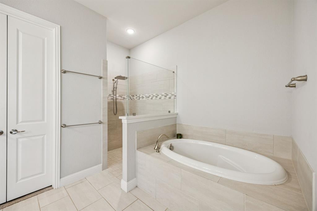 8116 Tramore The Colony, TX 75056 - Photo 18 of 36 a bathroom with a bathtub and a shower