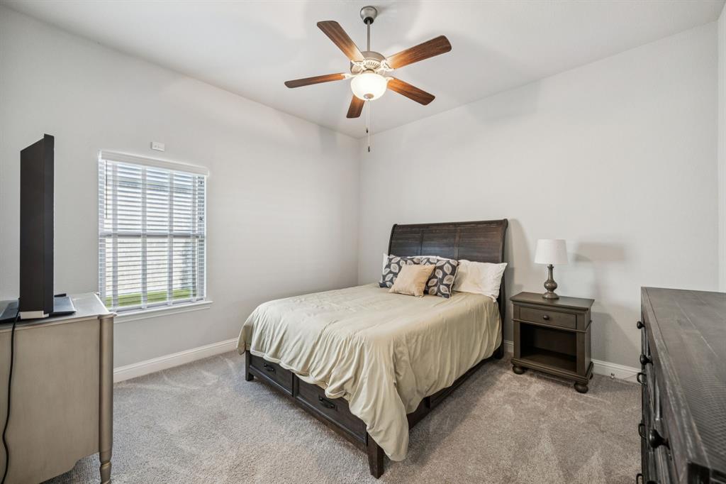 8116 Tramore The Colony, TX 75056 - Photo 20 of 36 a bedroom with a bed desk and a window