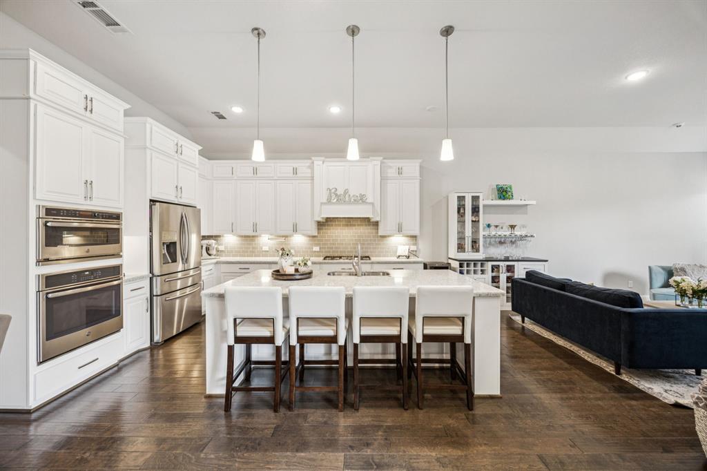 8116 Tramore The Colony, TX 75056 - Photo 8 of 36 a kitchen with kitchen island granite countertop a table and chairs in it