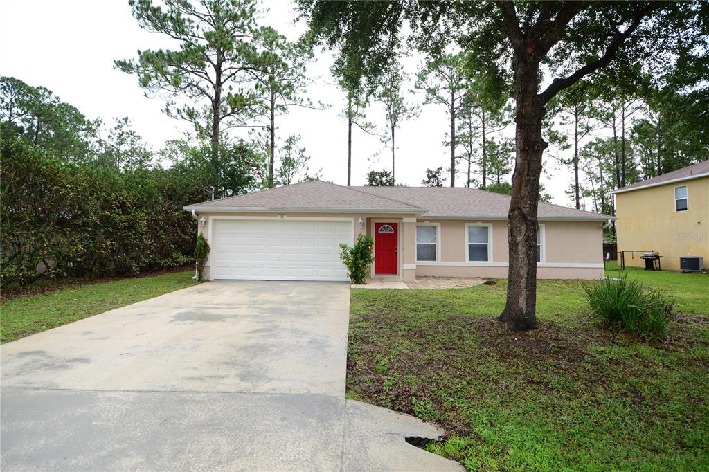 a view of a house with yard and a tree