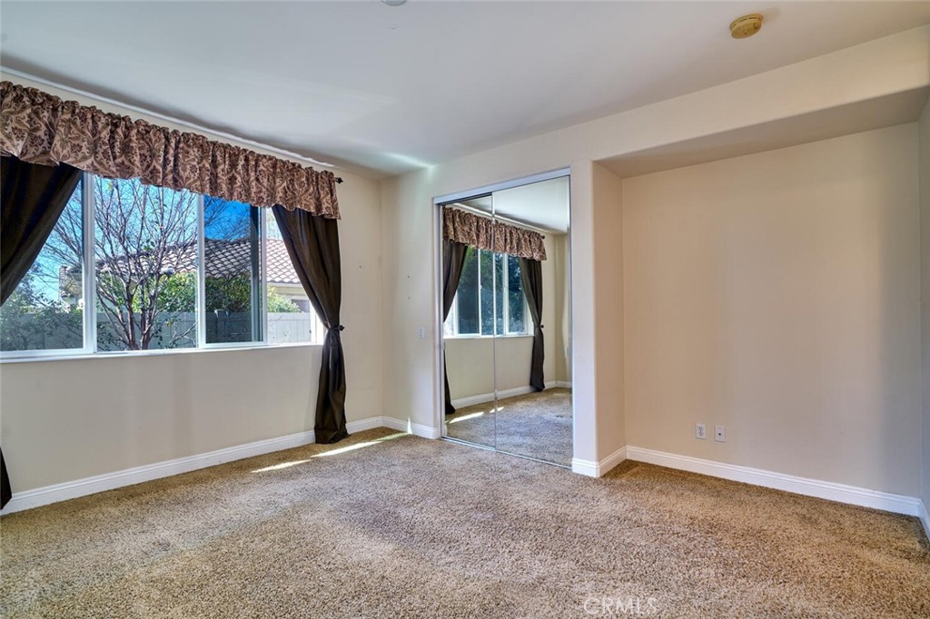 1143 Saguara Road Beaumont, CA 92223 - Photo 51 of 66 an empty room with windows and door