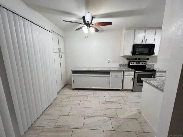 a kitchen with stainless steel appliances a stove a sink and a refrigerator