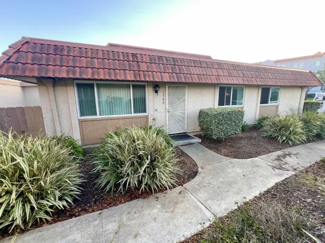 a front view of a house with garden