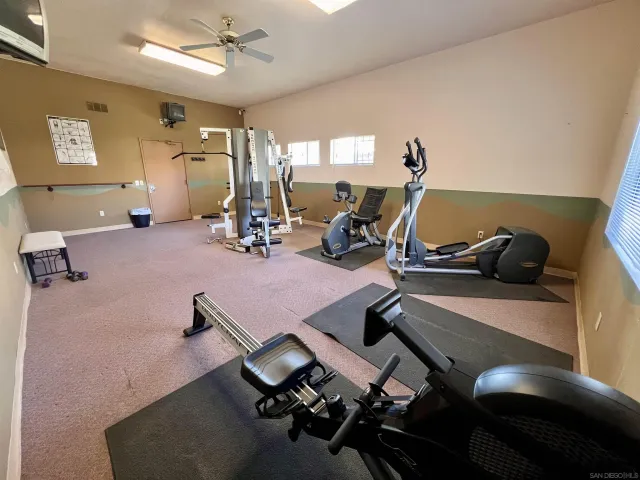 a room with gym equipment and view of living room