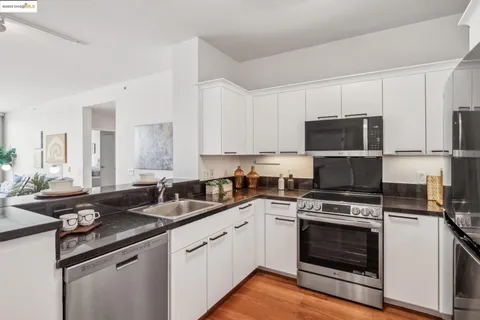a kitchen with sink a microwave and cabinets