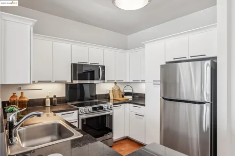 a kitchen with a refrigerator sink and microwave