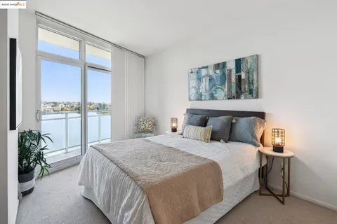 a bedroom with a large bed and a large window