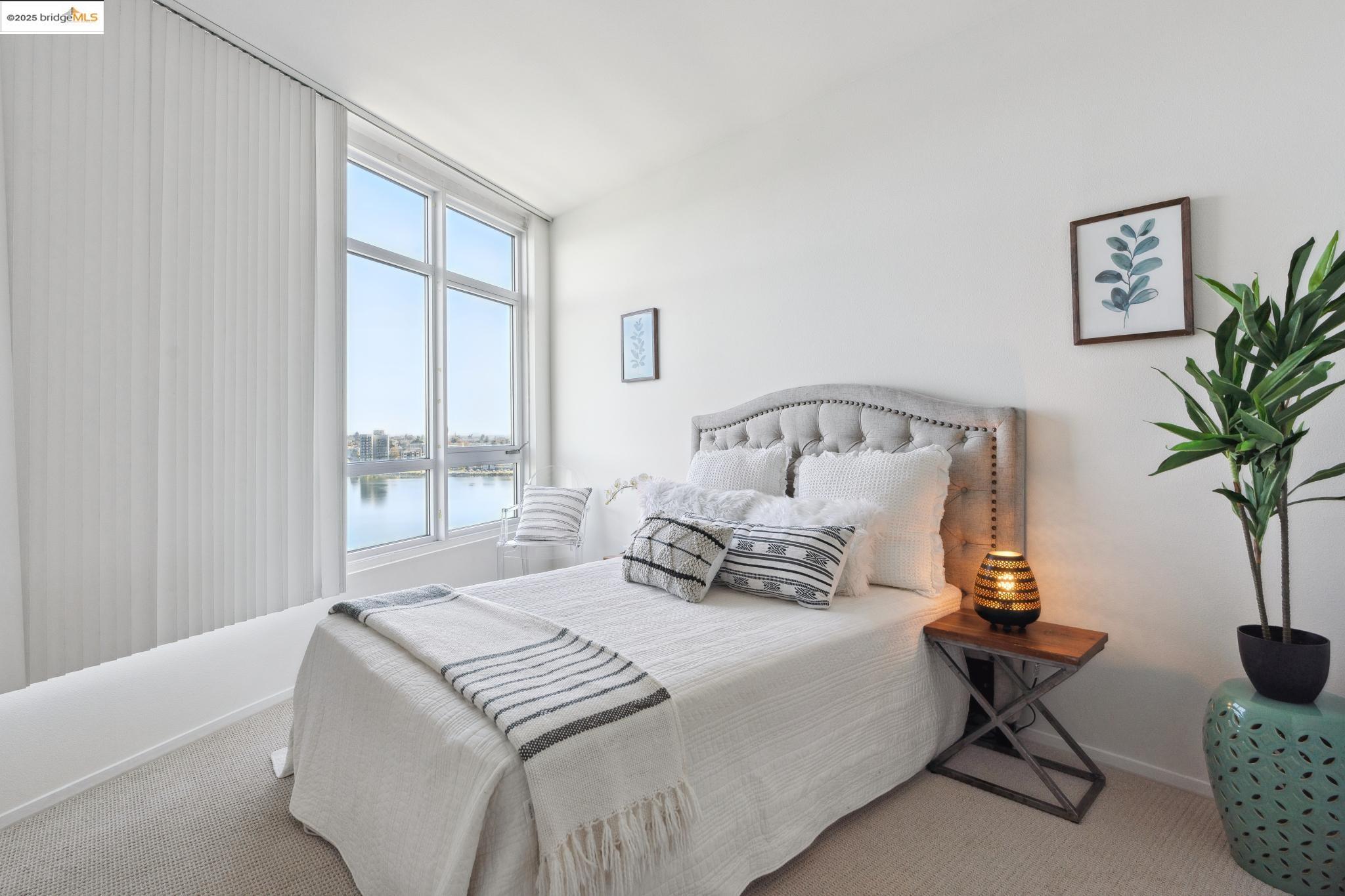 1 Lakeside Drive, Unit 1010 Oakland, CA 94612 - Photo 22 of 47 Carpeted bedroom featuring a water view and baseboards
