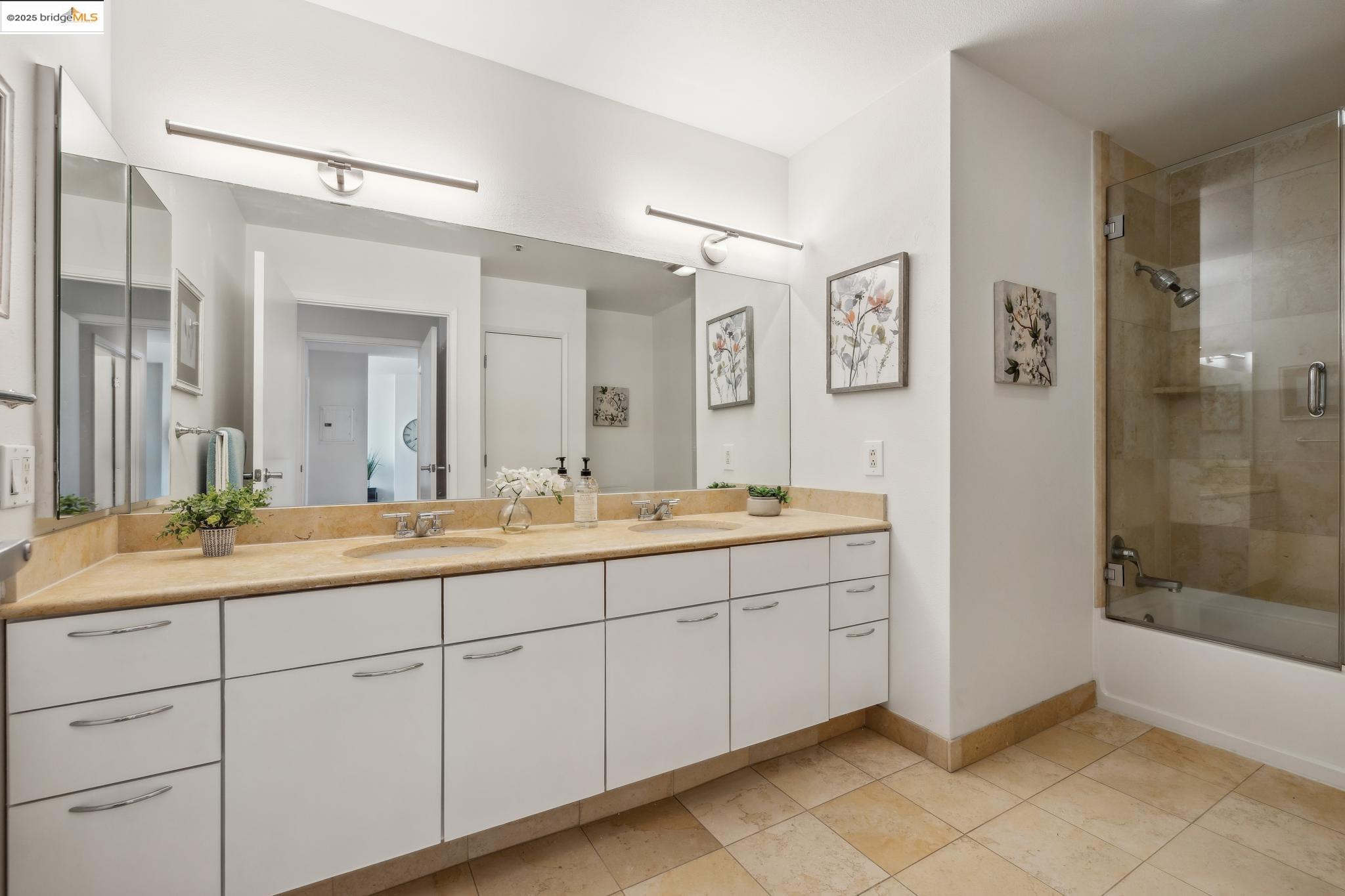 1 Lakeside Drive, Unit 1010 Oakland, CA 94612 - Photo 23 of 47 Bathroom with double vanity, bath / shower combo with glass door, and light tile patterned floors