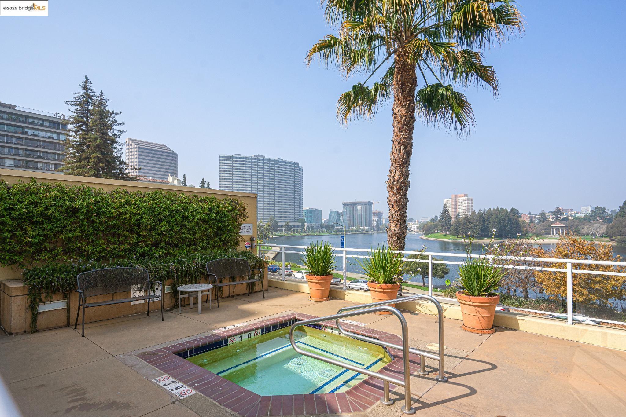 1 Lakeside Drive, Unit 1010 Oakland, CA 94612 - Photo 36 of 47 View of swimming pool featuring a city view, a patio, and a water view