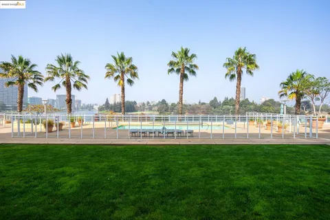 a view of a lake with a big yard and palm trees