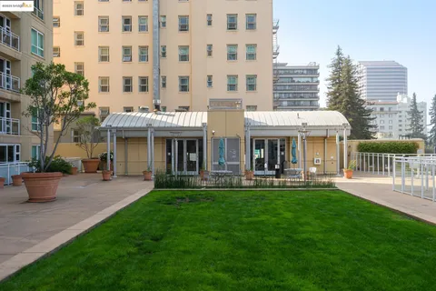 a front view of a building with a garden and patio