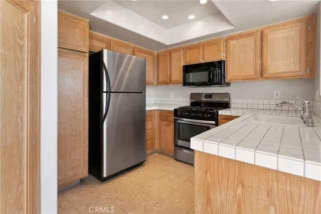 a kitchen with a refrigerator sink and microwave