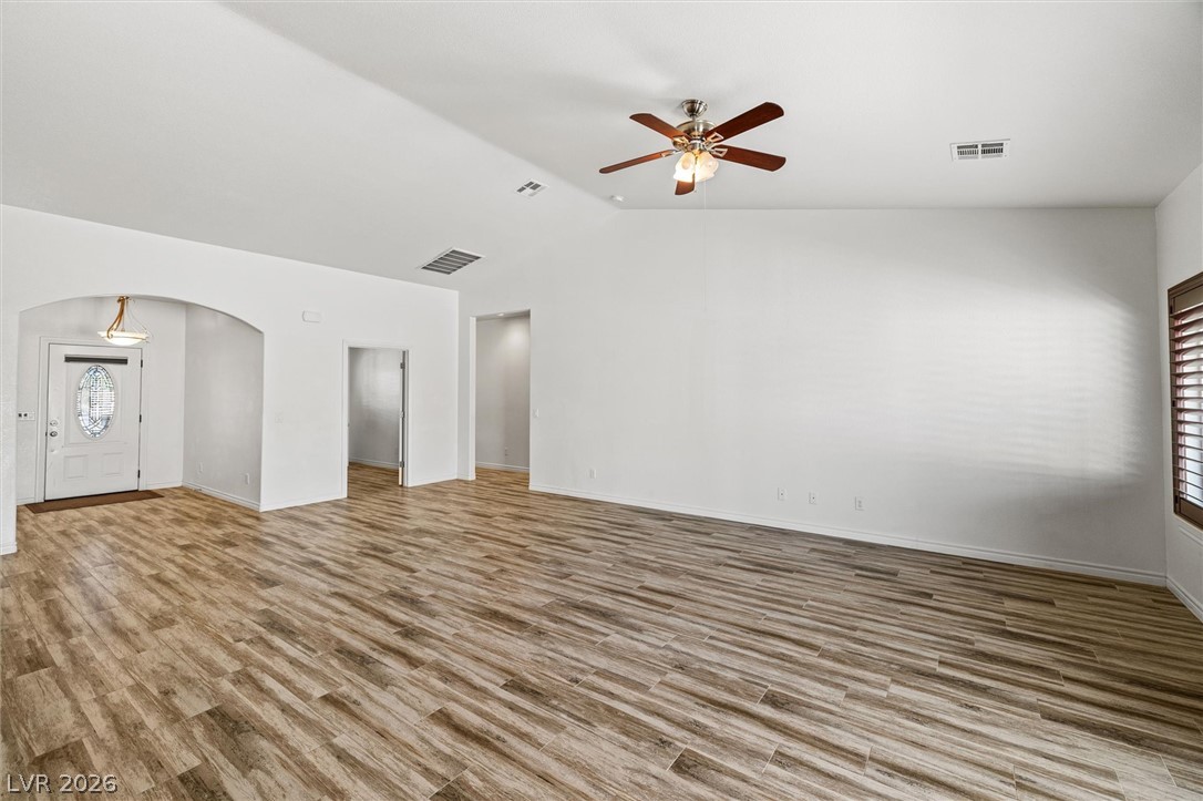 6720 Stubblefield Drive Pahrump, NV 89061 - Photo 10 of 51 A spacious, naturally illuminated room features vaulted ceilings and attractive wood-look tile flooring.