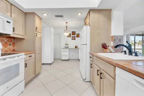 a view of a kitchen with white cabinets