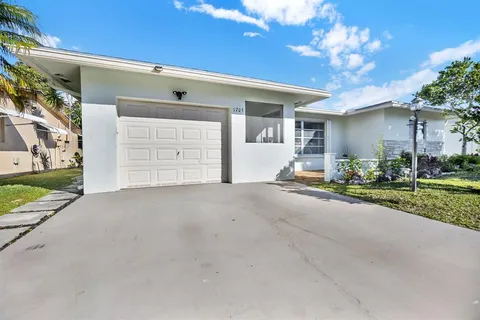 a view of a house with a yard and garage