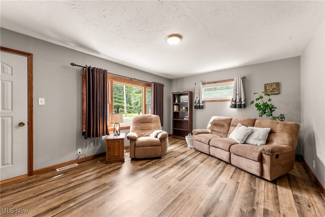 14808 Wheeler Road Lagrange, OH 44050 - Photo 11 of 50 Living room with plenty of natural light, a textured ceiling, and wood finished floors